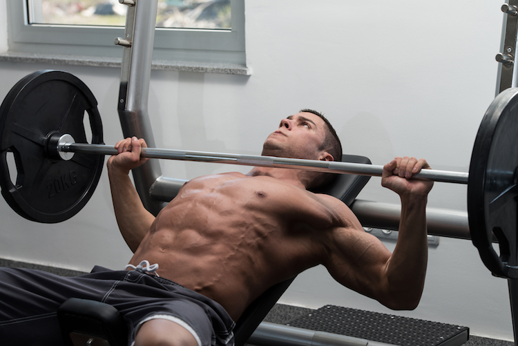 Man In Gym Exercising Chest On The Bench Press